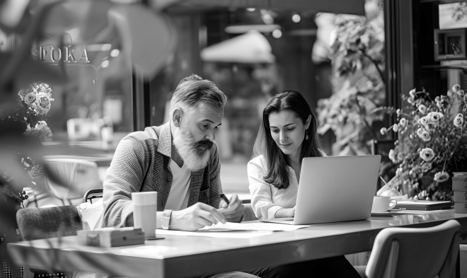 20 Essential skills an entrepreneur must have 6 A bearded man and a young woman working together in a cafe, highlighting the essential skills an entrepreneur must have, including teamwork, focus, and perseverance.
